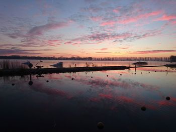 Scenic view of calm sea at sunset