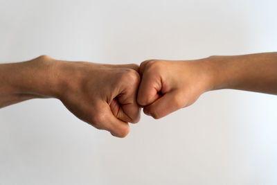 Midsection of man making face against white background