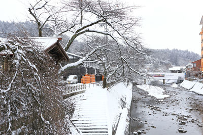 Snow covered houses and buildings against sky