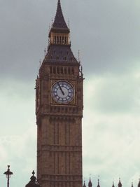 Low angle view of clock tower against sky