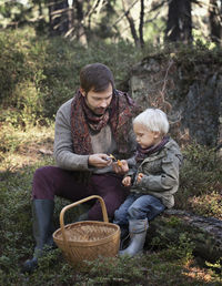 Father with son picking mushrooms