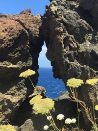 Rock formations by sea against sky