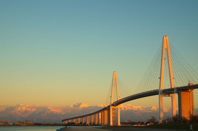 View of suspension bridge against sky during sunset