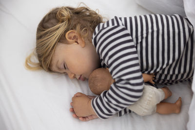 High angle view of baby sleeping on bed at home