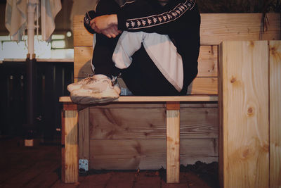 Low section of man standing on table