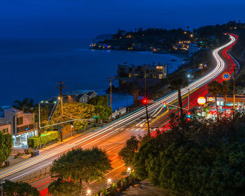 High angle view of light trails on road at night