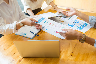 High angle view of people working on table