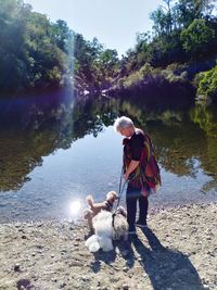 Full length of man with dog on water