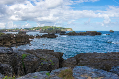 A nice view of the sea coast with rocks in the water