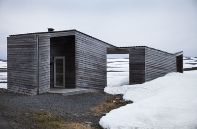 Wooden sheds in winter landscape