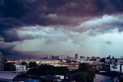 View of townscape against dramatic sky