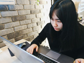 High angle view of young woman using laptop