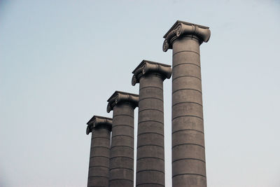 Low angle view of columns against sky