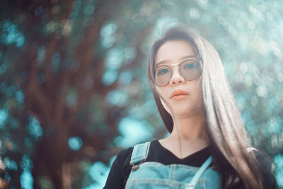 Portrait of young woman looking away in forest