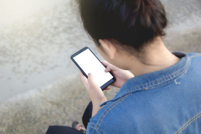 Midsection of woman using mobile phone