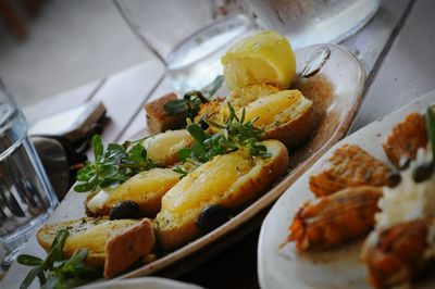 Close-up of greek food served in plates on table