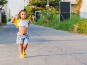 Full length of cute girl on road