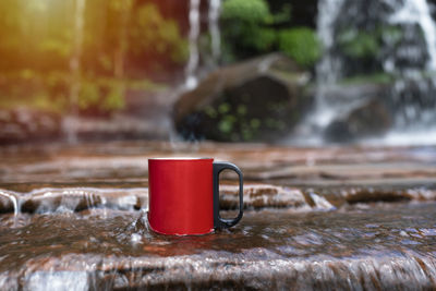 Cup of coffee on table against blurred background