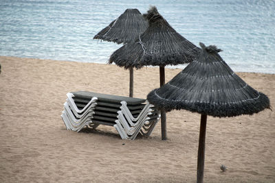 Deck chairs on sand at beach