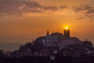 Buildings in town at sunset