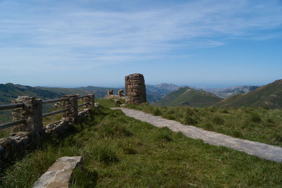 Built structure on landscape against sky