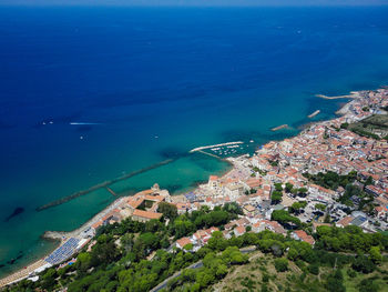 High angle view of sea and buildings in city