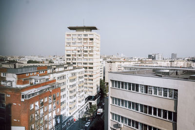 Buildings in city against clear sky