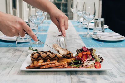 Midsection of person preparing food on table