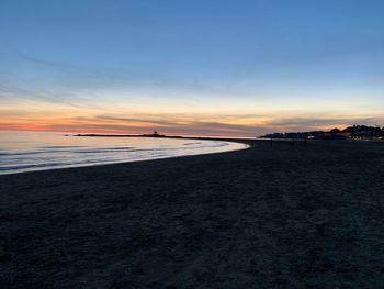 Scenic view of beach against sky during sunset