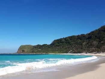 Scenic view of sea against clear blue sky