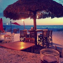 Scenic view of calm beach at sunset