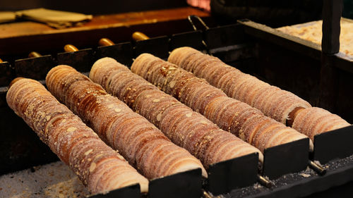 Trdelnik bakery on the christmas market in prague, cz. baking popular trdlo at the street stalls.