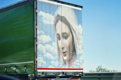 Portrait of young woman against sky