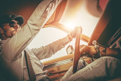 Low angle view of man driving car