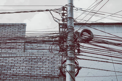 Low angle view of electricity pylon against sky