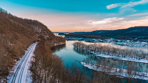 Scenic view of frozen lake against sky during winter