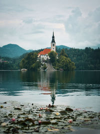 Scenic view of lake and buildings against sky, church on island at lake bled, slovenia
