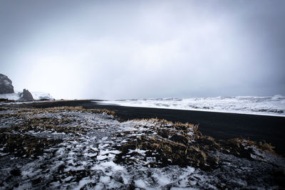 Scenic view of sea against sky during winter