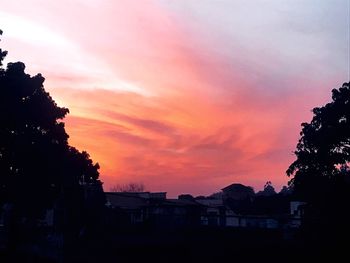 Silhouette buildings against sky during sunset