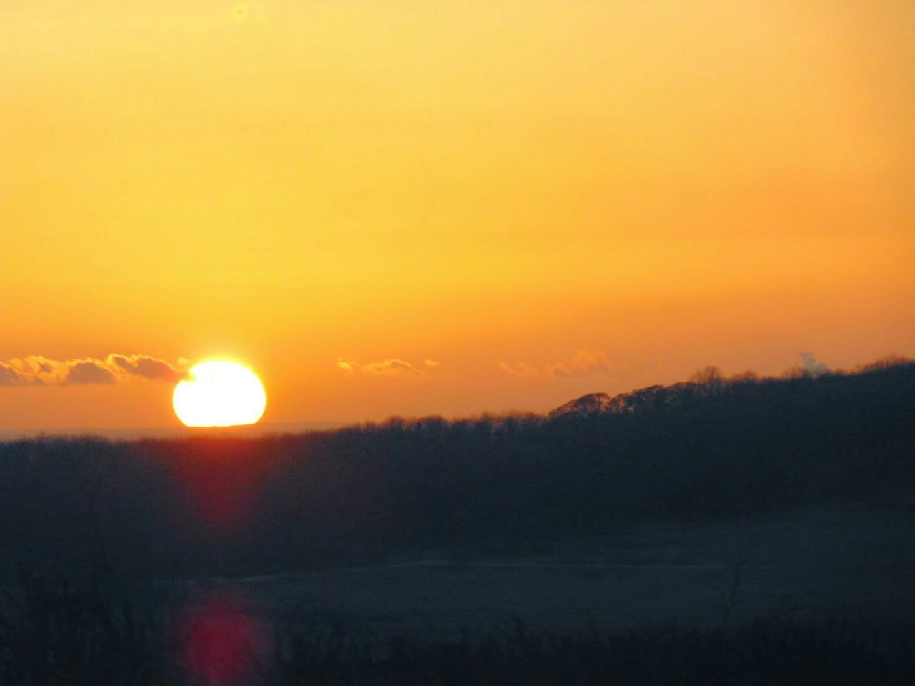 sunset, orange color, sun, tranquil scene, scenics, beauty in nature, tranquility, silhouette, landscape, idyllic, nature, sky, copy space, non-urban scene, sunlight, outdoors, field, clear sky, majestic, no people