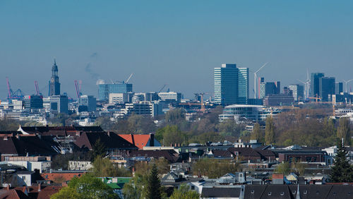 Cityscape against clear blue sky