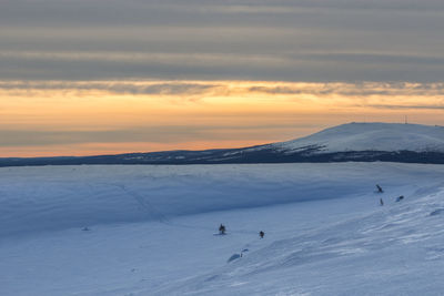 Scenic view of snowcapped mountains against sky during sunset lapland