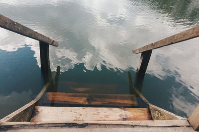 High angle view of wooden staircase in lake