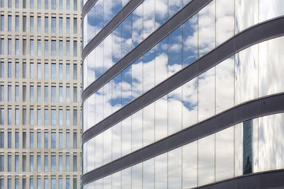 Low angle view of glass building against sky