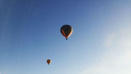 Low angle view of hot air balloons flying in sky