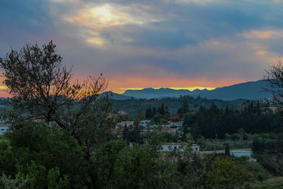 Scenic view of townscape against sky during sunset