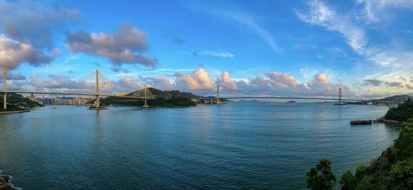 View of bridge over sea against cloudy sky