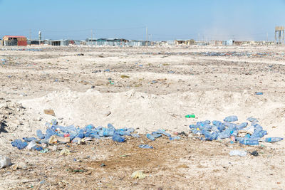 Garbage on sand against the sky