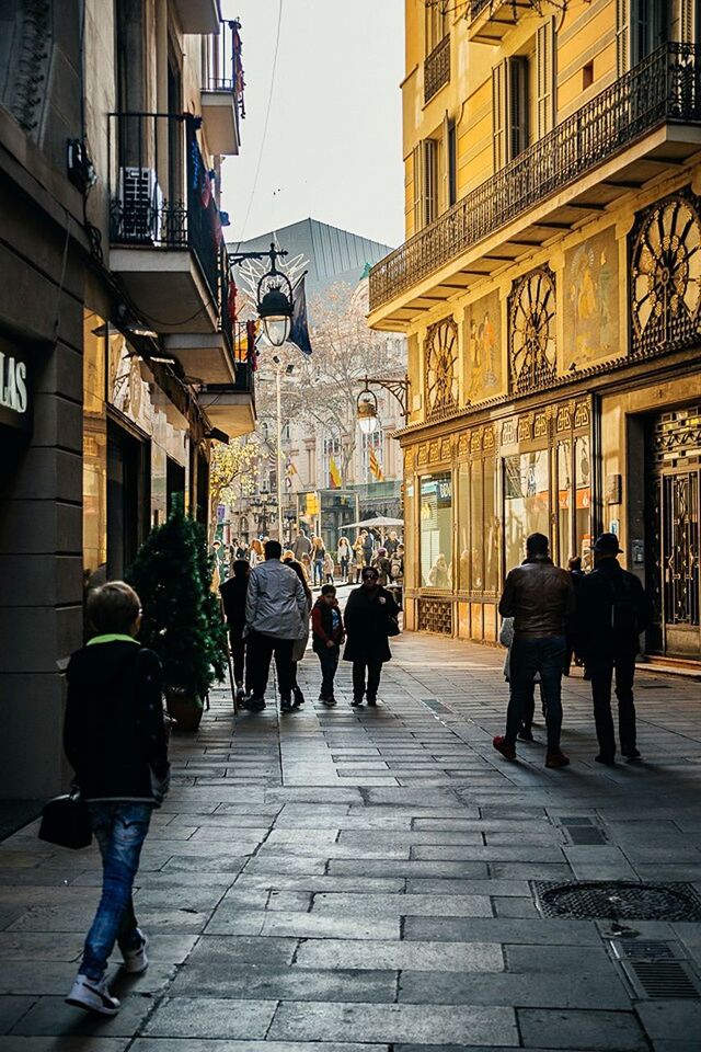 PEOPLE ON STREET AGAINST SKY