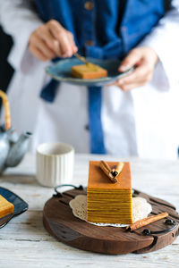 Thousand layer cake and hand in frame . still life photography